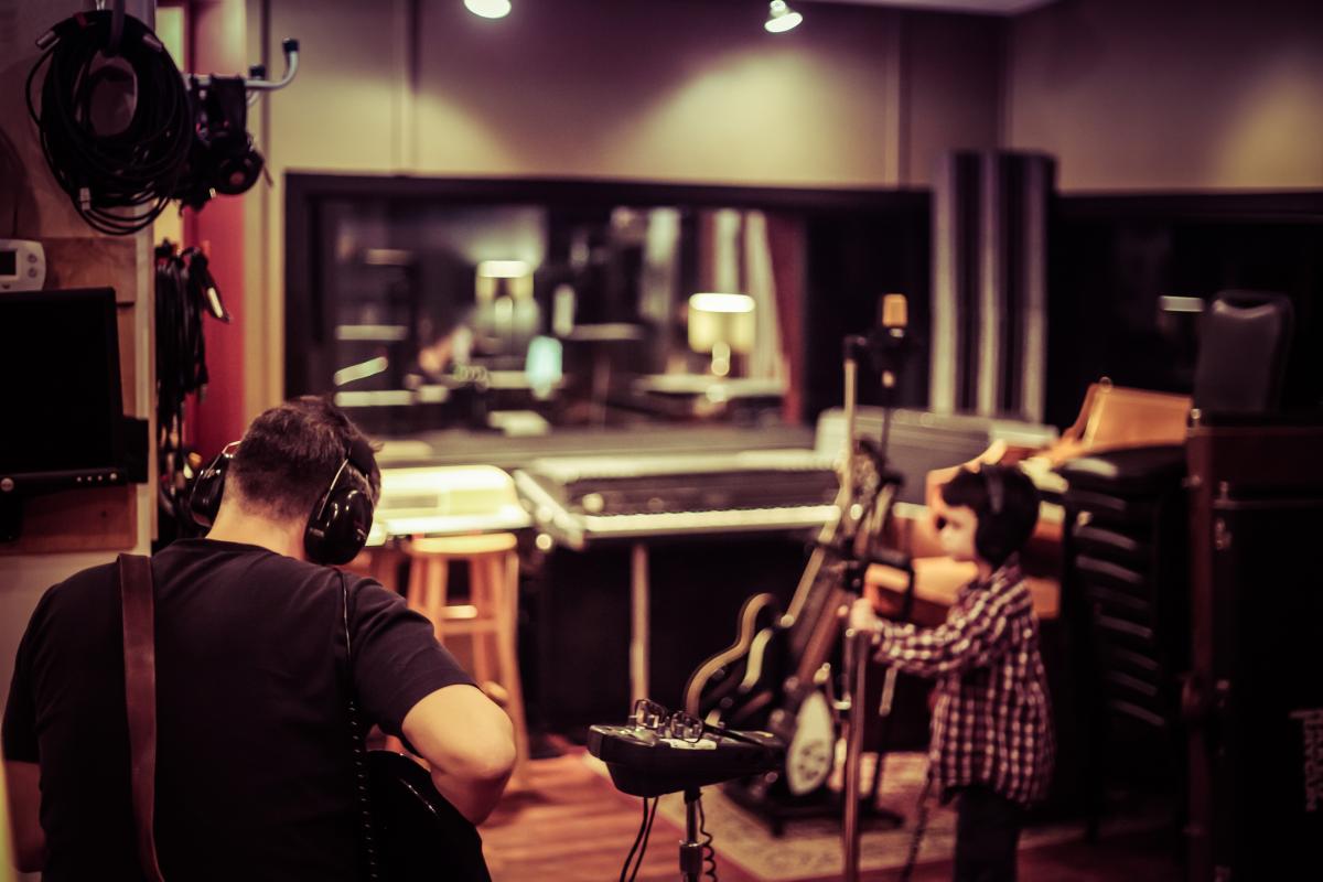 Playing guitar in the studio