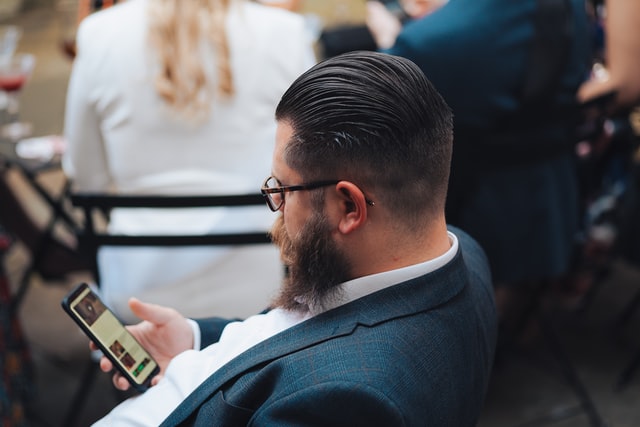Man looking at social media app on phone