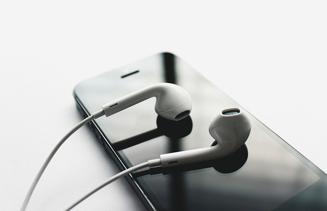 Earbuds on top of smartphone | 6 Ways to Grow Your Music Streaming