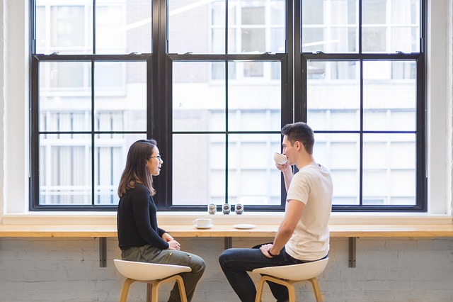 Two people sitting and talking