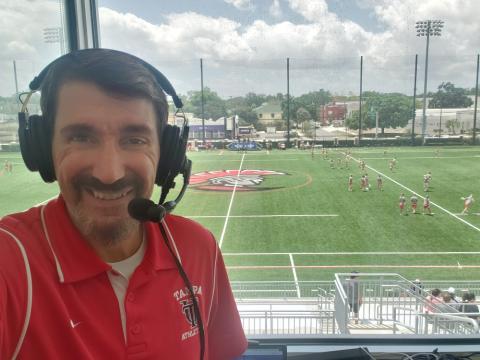 Bruce Wawrzyniak wearing headphones at a lacrosse game broadcast