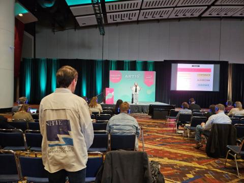 A speaker on one of the three stages in the ballroom at Podcast Movement Evolutions