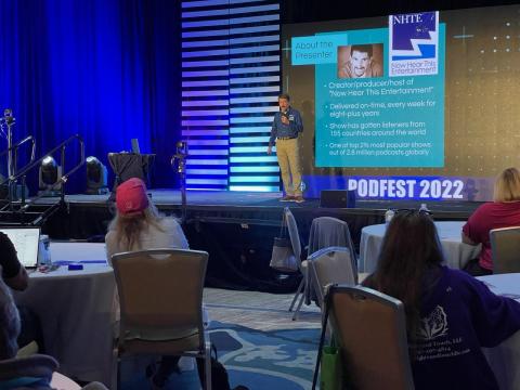 Bruce Wawrzyniak on stage in Orlando speaking at Podfest Bruce Wawrzyniak on stage in Orlando speaking at Podfest