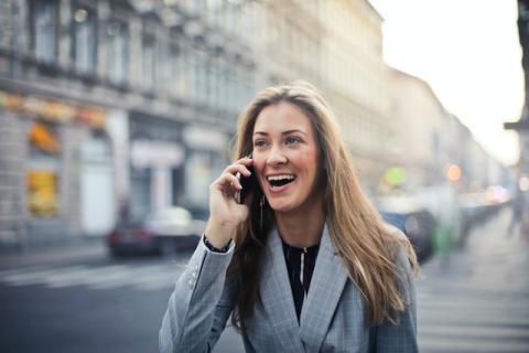 Long blonde-haired girl on phone outside with surprised smiling look Long blonde-haired girl on phone outside with surprised smiling look