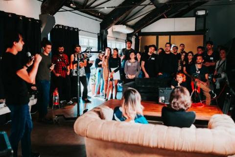 A group listens to a speaker at a networking event