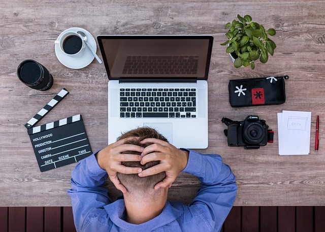 Sitting frustrated at laptop